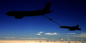 KC-135 aircraft flying side by side with another plane