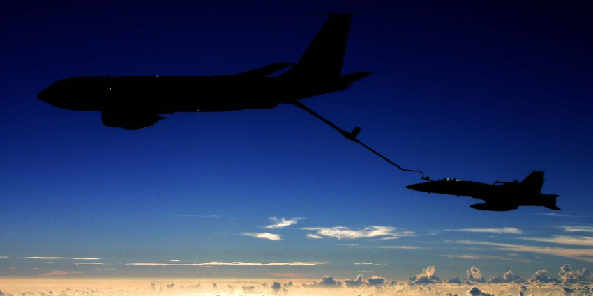 KC-135 aircraft flying side by side with another plane