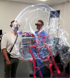 A patient and a clinician have an augmented reality consultation.